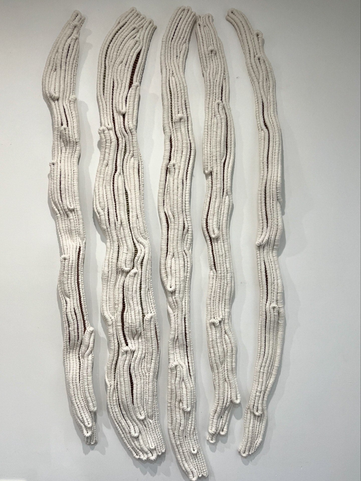 Sculptural rope wall artwork with organic vertical lines and natural cotton texture