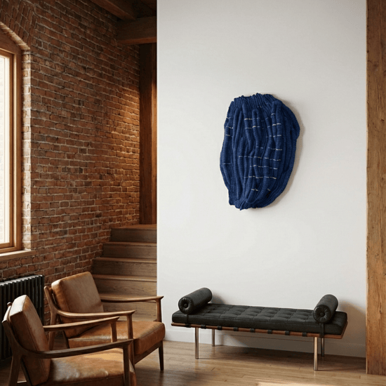 Blue sculptural fibre wall art in a modern brick interior