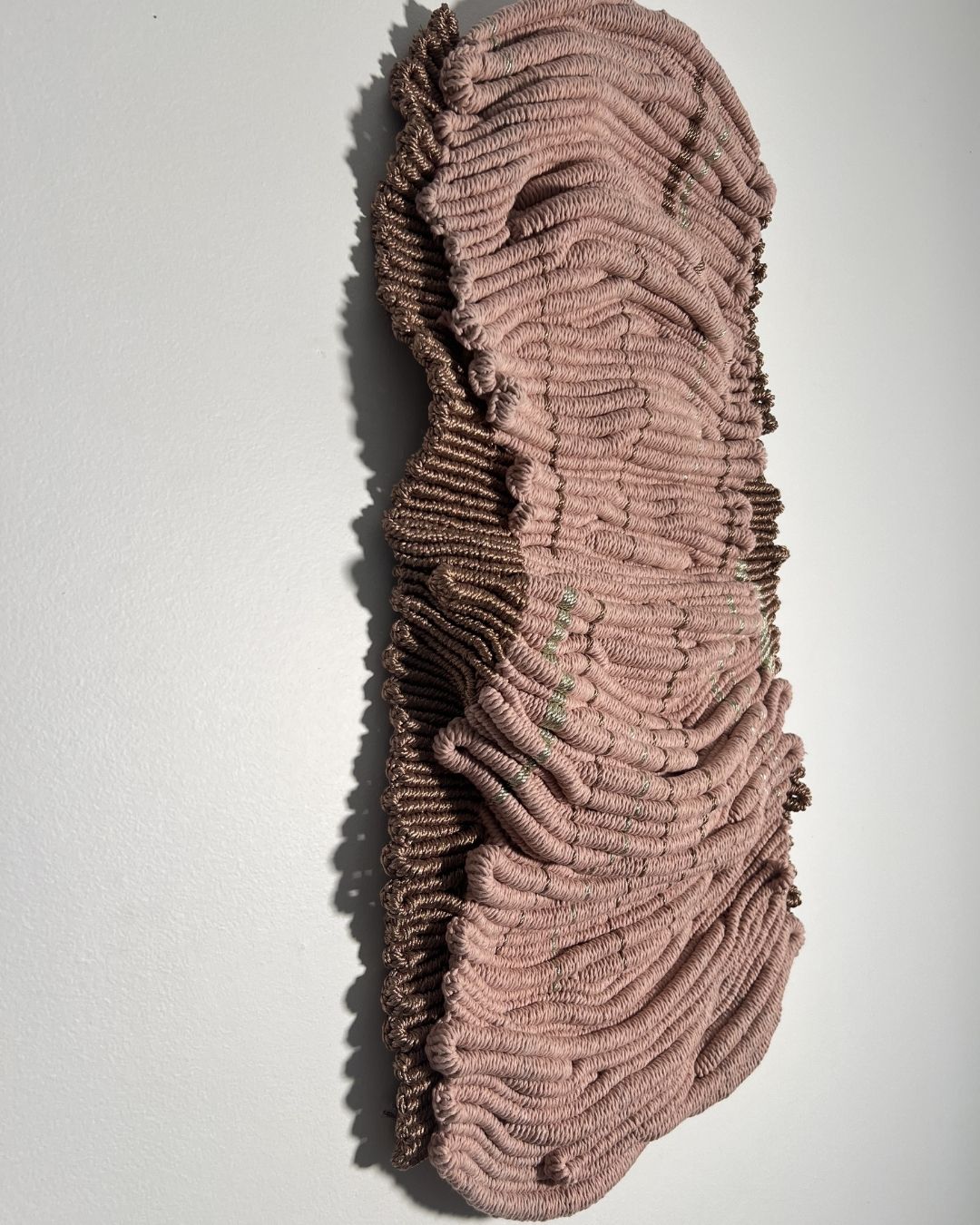 Contemporary fibre sculpture with organic form and metallic highlights