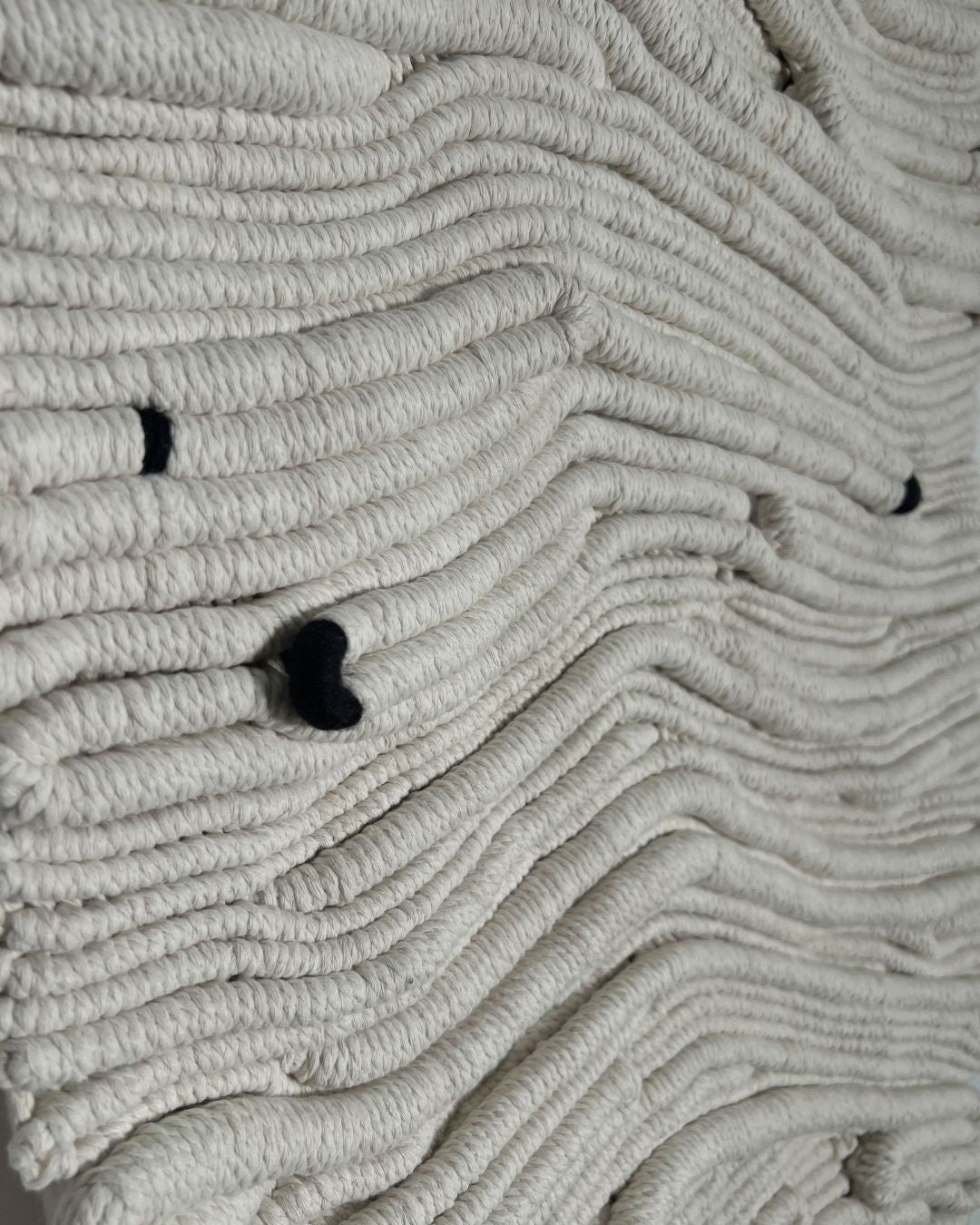 Close-up of textured fibre wall art, natural tones