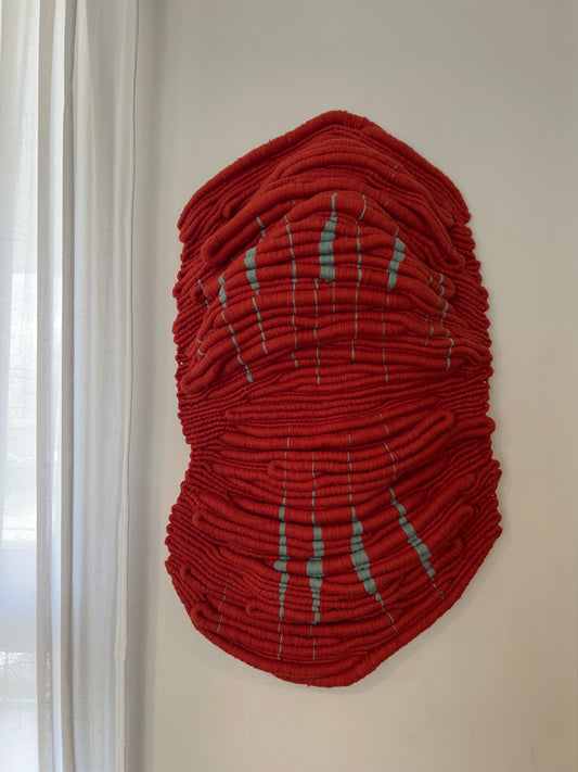 Front view of Wounded Healer, an original red hand-knotted sculptural textile artwork by Melbourne fibre artist Kasia Dudkiewicz.