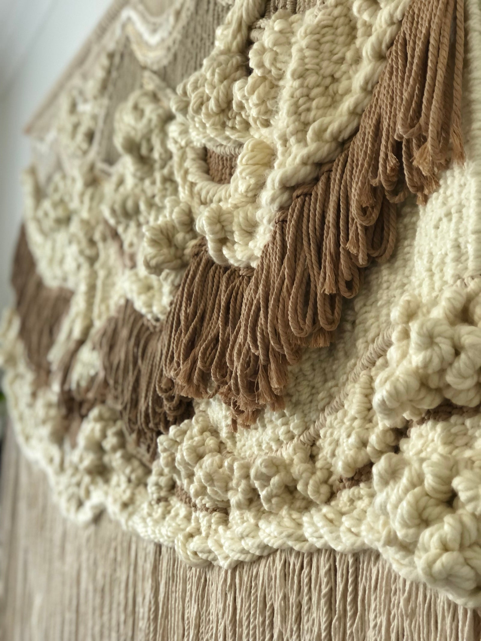 Custom macramé wall art in progress, tailored to fit a specific interior design style.